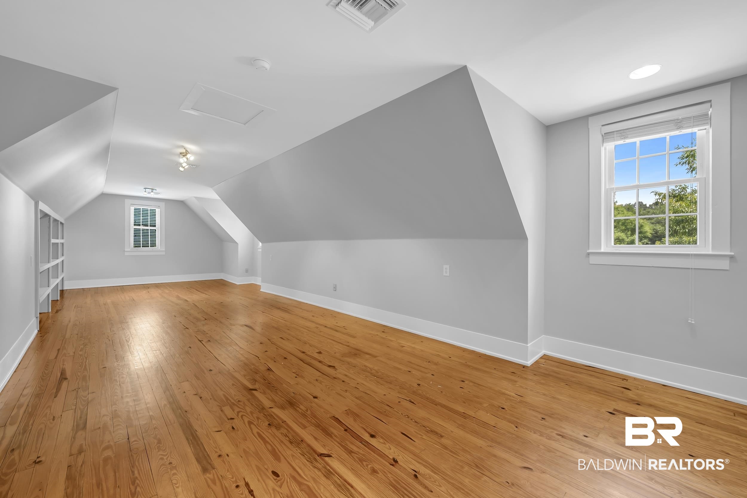43199 Pine Grove Road Bay Minette, AL 36507 - Photo 69 of 71 Expansive room featuring wood-finish flooring, two large windows, built-in shelving, and recessed lighting