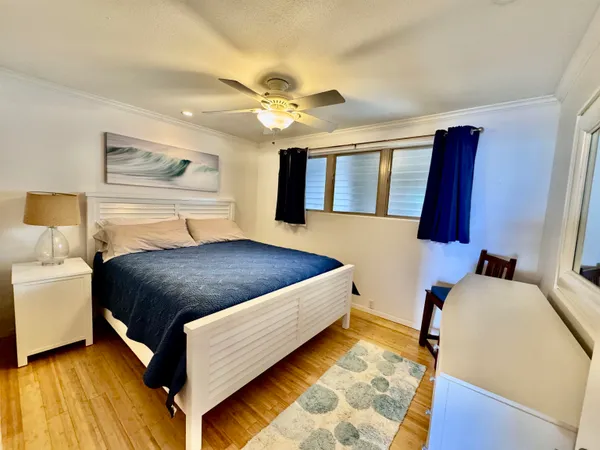 a bedroom with a large bed and a chandelier