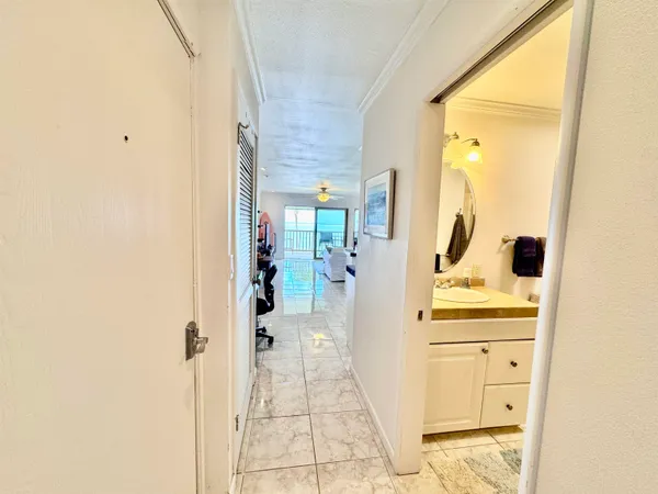 a bathroom with a granite countertop sink a mirror and shower