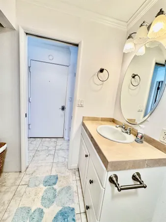 a bathroom with a sink mirror and vanity