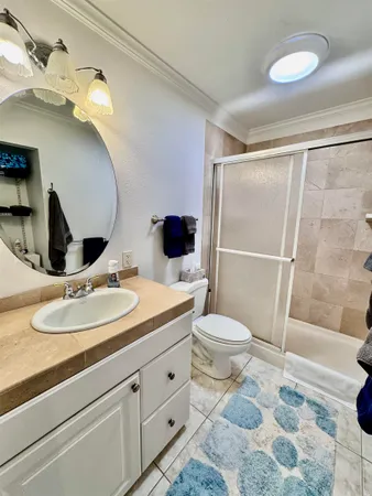 a bathroom with a sink toilet a mirror and shower