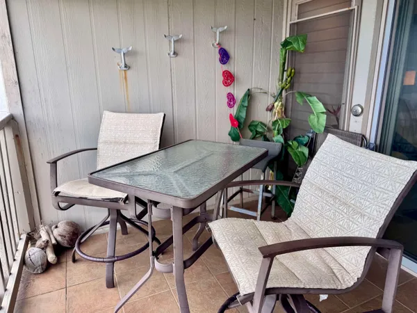 a view of a room with furniture and wooden floor