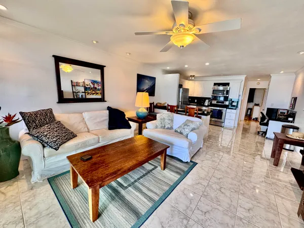a living room with furniture and a chandelier