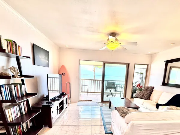 a living room with furniture fireplace and a large window