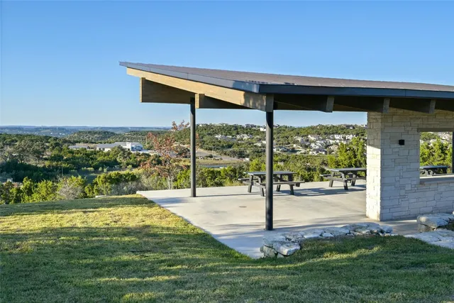 a view of a patio with a table chairs and couches under an umbrella