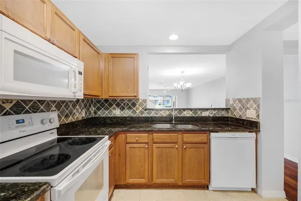 a kitchen with a refrigerator sink and cabinets