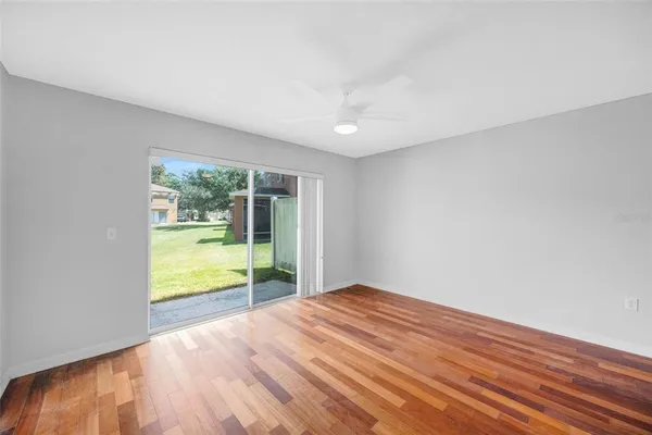 a view of empty room with wooden floor