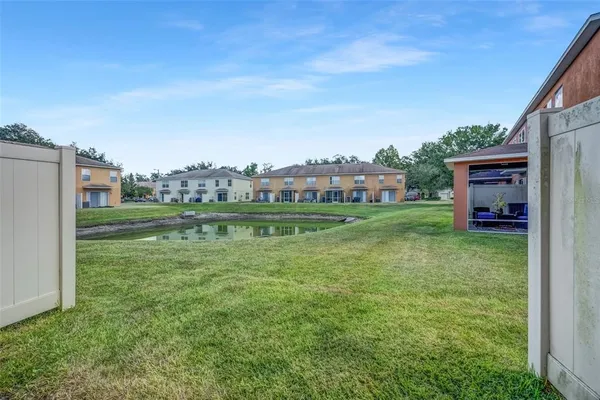 front view of a brick house with a yard