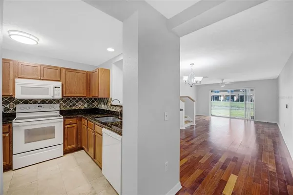 a kitchen with stainless steel appliances granite countertop a stove and a refrigerator