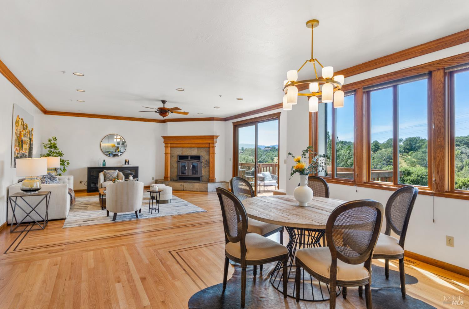 10 Lockton Lane Novato, CA 94945 - Photo 18 of 68 Great room seating area with wood-burning fireplace, casual dining nearby, and sliding glass doors opening to the view deck.
