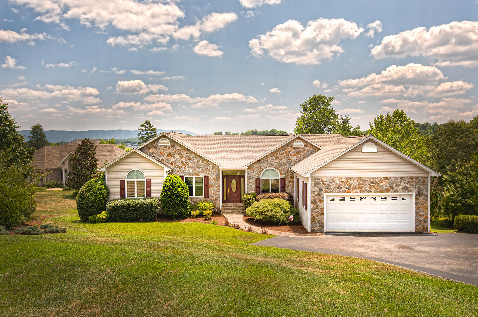 a view of a house with a yard and garage