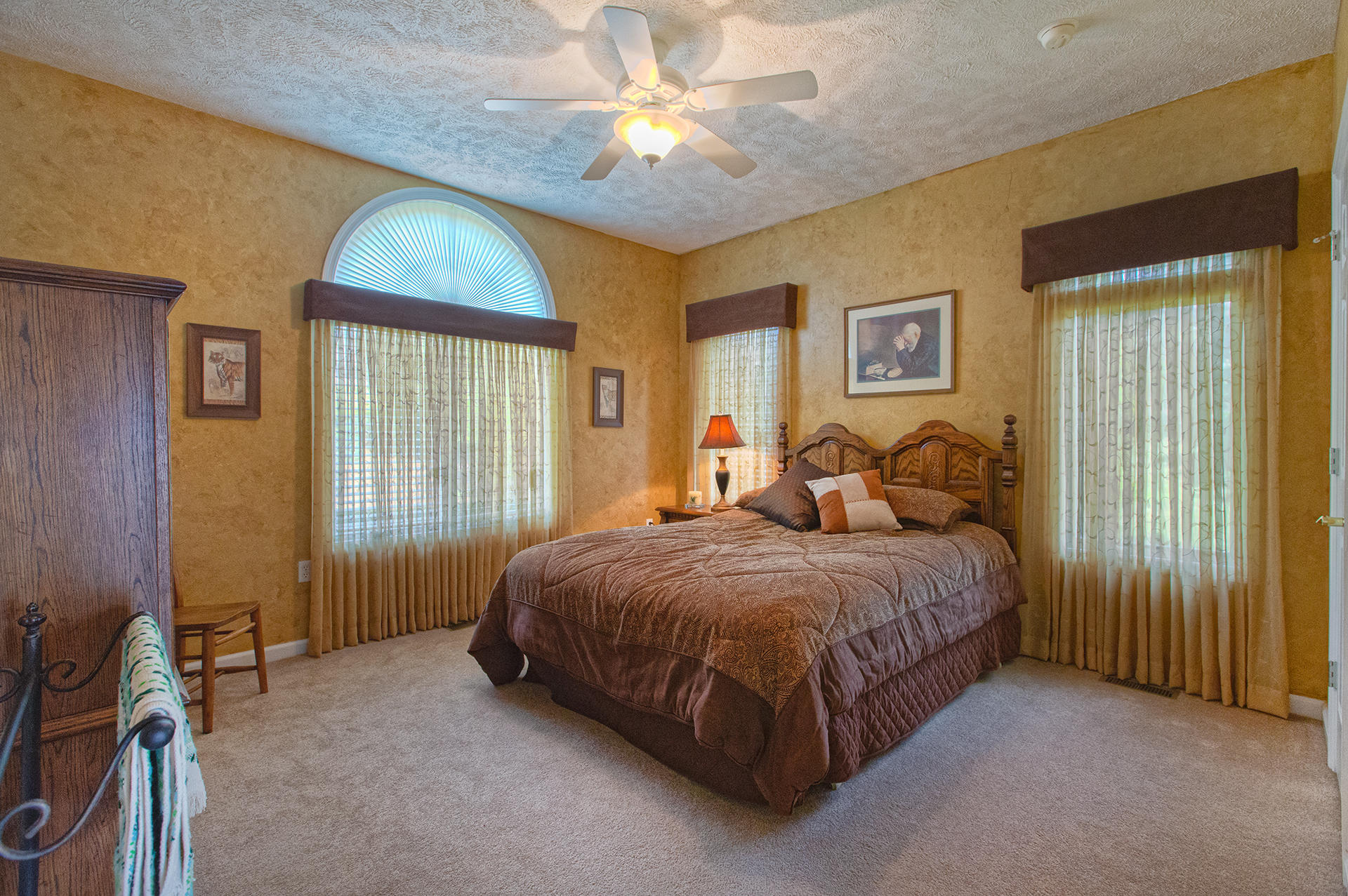270 Calypso Road Moneta, VA 24121 - Photo 11 of 35 a spacious bedroom with a bed and a chandelier