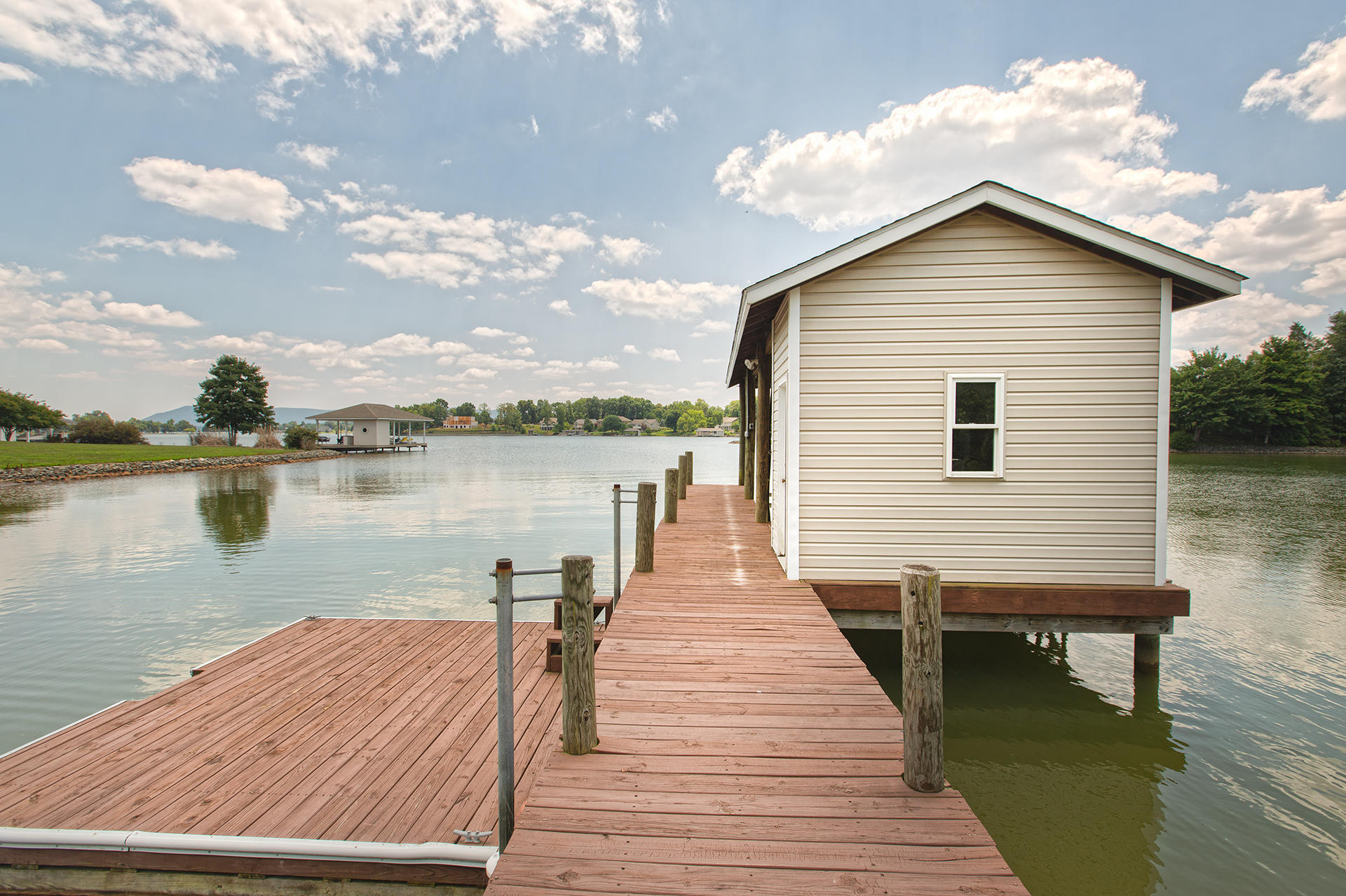 270 Calypso Road Moneta, VA 24121 - Photo 27 of 35 a wooden deck with lake view