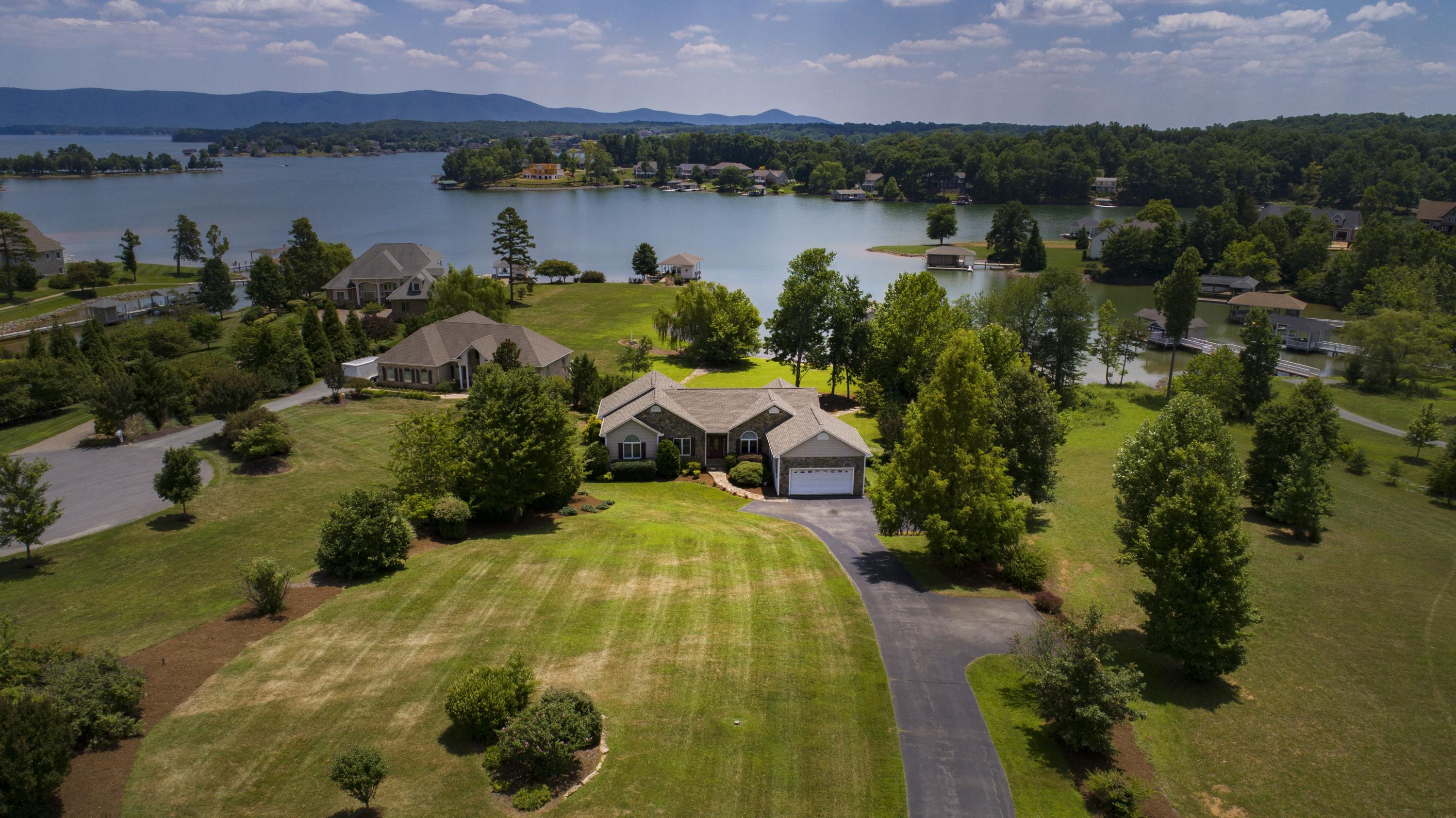 270 Calypso Road Moneta, VA 24121 - Photo 31 of 35 a view of a lake with a houses and a mountain view