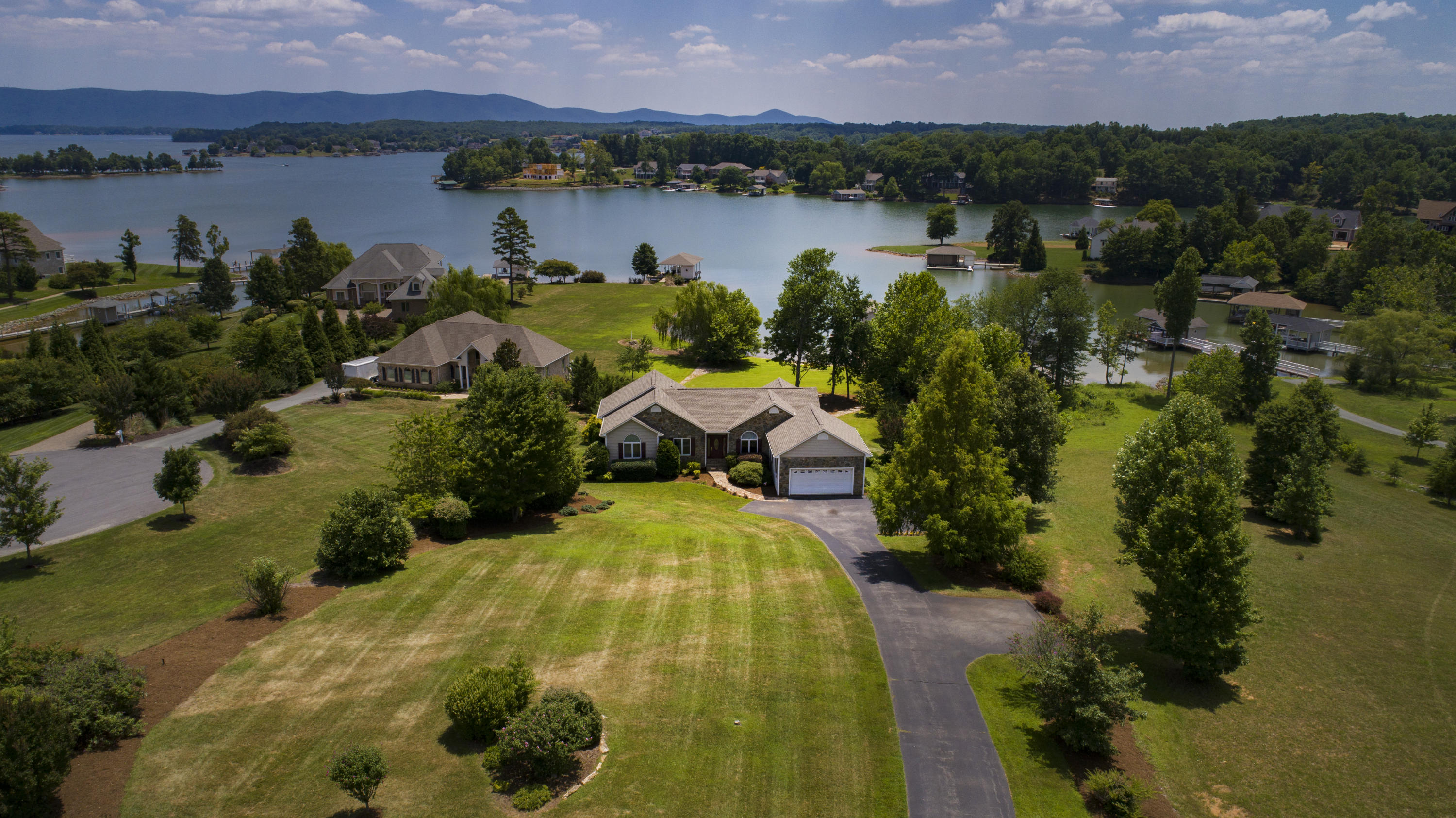 270 Calypso Road Moneta, VA 24121 - Photo 32 of 35 a view of a lake with a houses and a mountain view