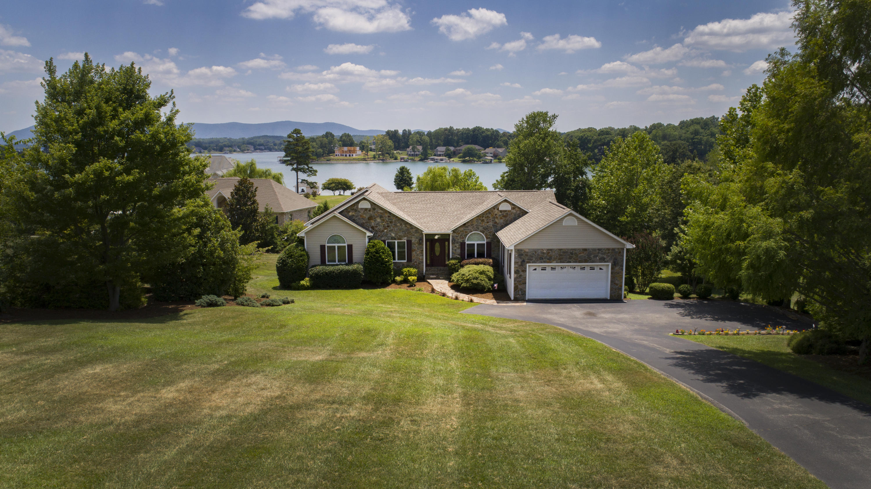 270 Calypso Road Moneta, VA 24121 - Photo 33 of 35 a front view of a house with a yard and trees