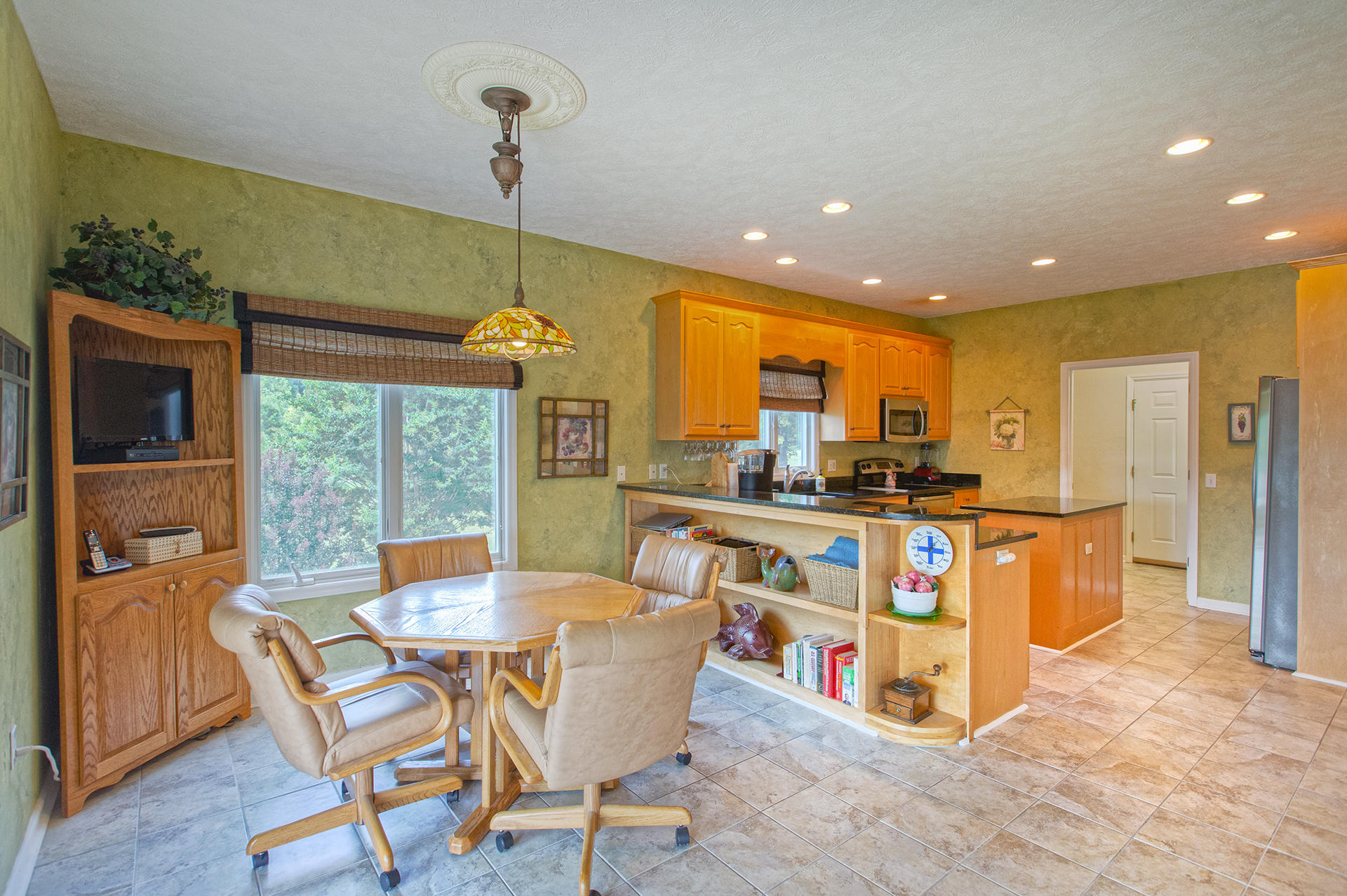 270 Calypso Road Moneta, VA 24121 - Photo 7 of 35 a kitchen with stainless steel appliances kitchen island granite countertop a table and chairs