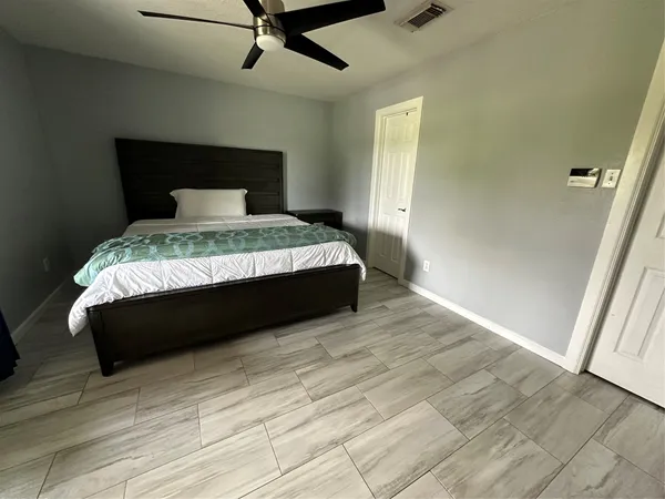 a bed sitting in a bedroom next to a window