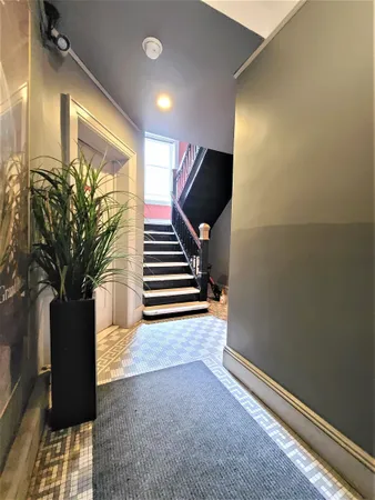 a view of an entryway with wooden floor