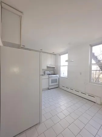 a view of a storage & utility room with cabinets