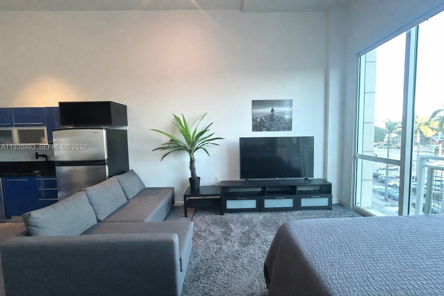 253 Northeast 2nd Street, Unit 333 Miami, FL 33132 - Photo 2 of 20 a living room with furniture and a flat screen tv