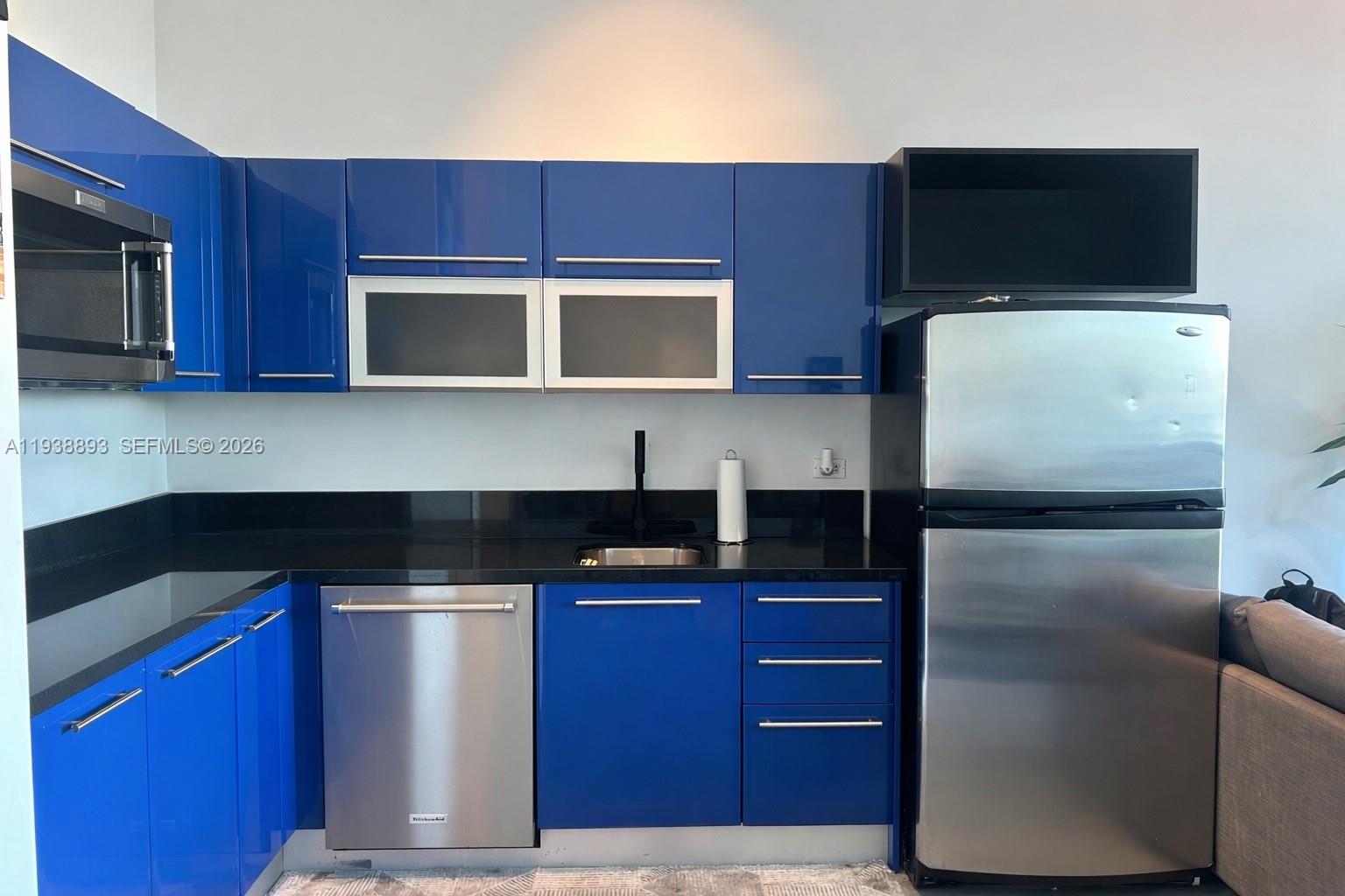 253 Northeast 2nd Street, Unit 333 Miami, FL 33132 - Photo 4 of 20 a kitchen with a refrigerator sink and microwave