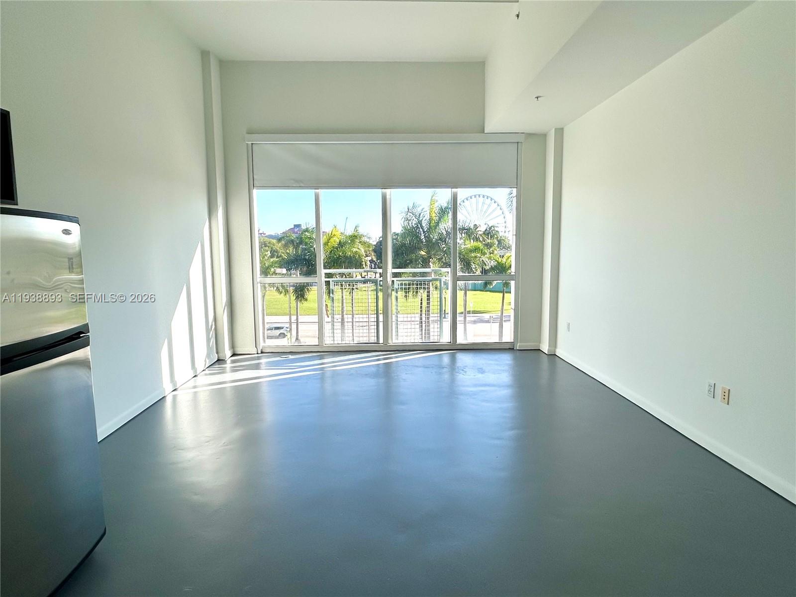 253 Northeast 2nd Street, Unit 333 Miami, FL 33132 - Photo 8 of 20 a view of a livingroom with wooden floor and a window
