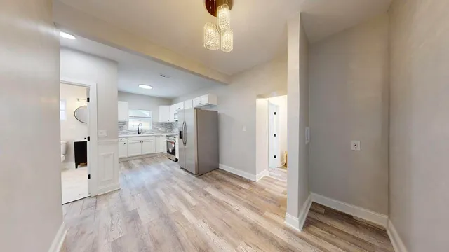 a view of a kitchen with wooden floor