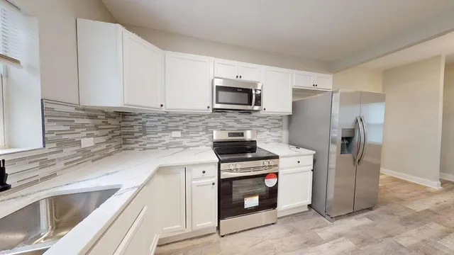 a kitchen with a refrigerator sink and microwave
