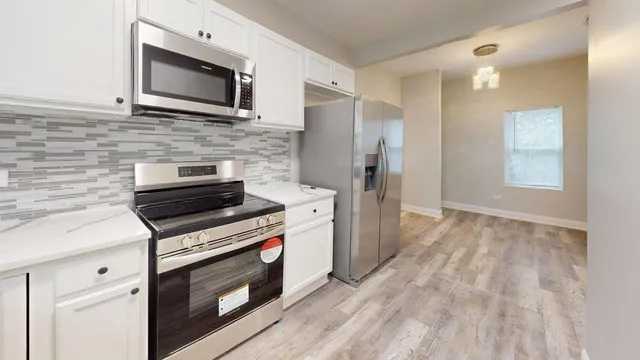 a kitchen with a stove microwave and refrigerator