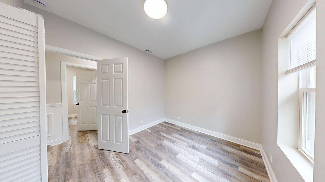 1379 Roosevelt Place, Unit 1 Gary, IN 46404 - Photo 9 of 24 an empty room with wooden floor and a window