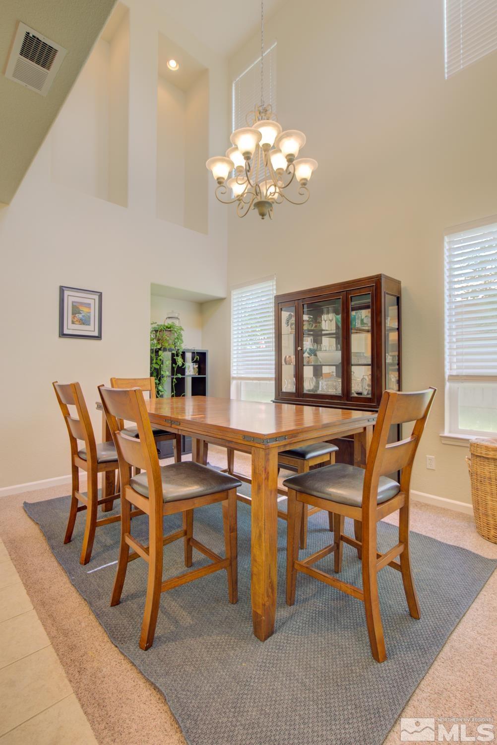 13710 Seabiscuit Drive Reno, NV 89521 - Photo 8 of 32 a view of a dining room with furniture and a chandelier