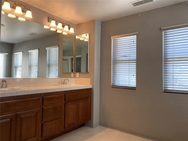 a bathroom with windows and bathtub