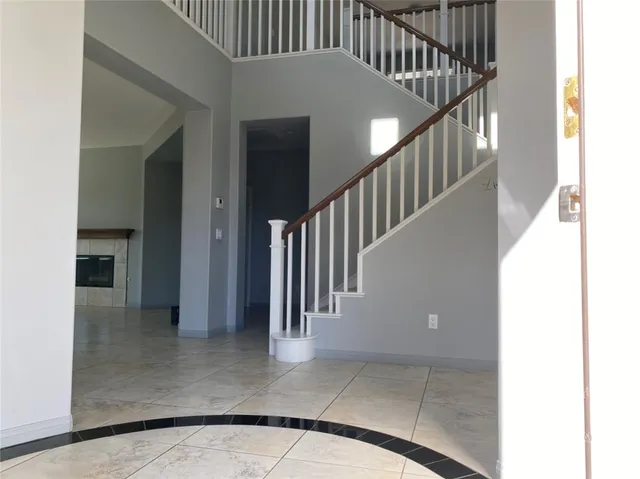 a view of staircase with white walls and railing