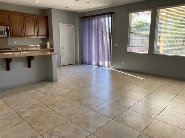 a large kitchen with stainless steel appliances granite countertop a stove and cabinets