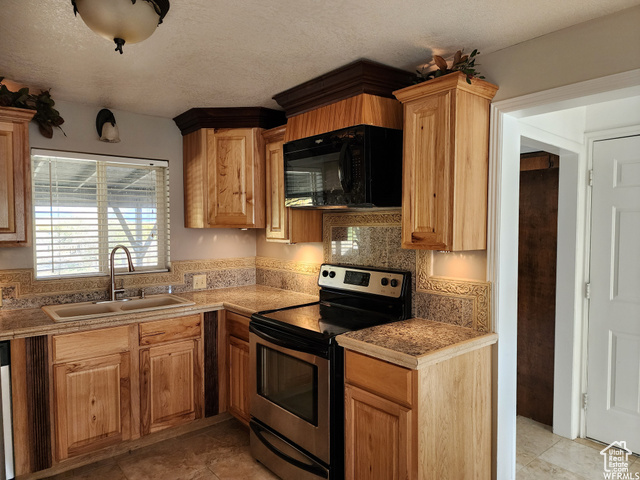 474 North Fairgrounds Road Price, UT 84501 - Photo 1 of 1 Kitchen featuring sink, backsplash, stainless steel range with electric stovetop, and light tile floors