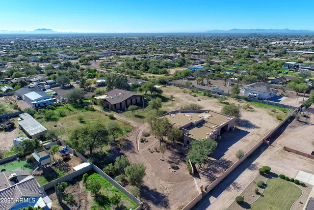 an aerial view of a house with a yard