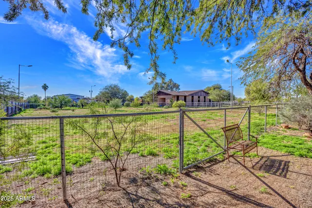 an empty room with windows and ceiling fan