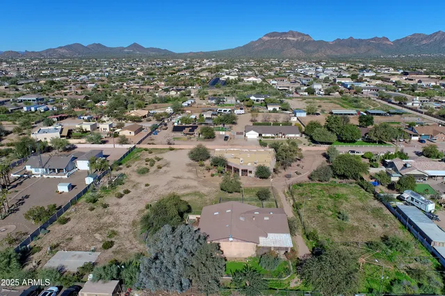 a view of a hallway with wooden floor and a cabinet