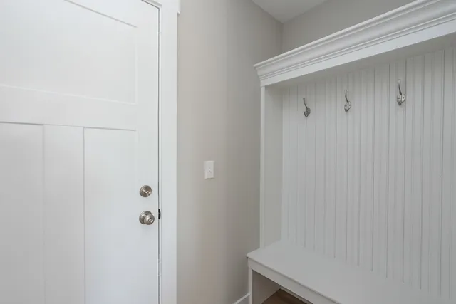 an empty room with ceiling fan and wooden floor