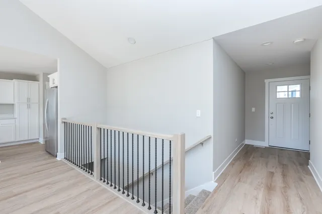 an empty room with a ceiling fan and window