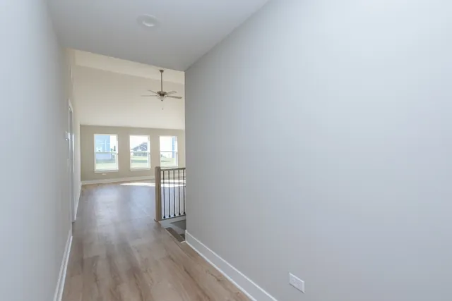 a view of a kitchen with a sink and dishwasher with wooden floor