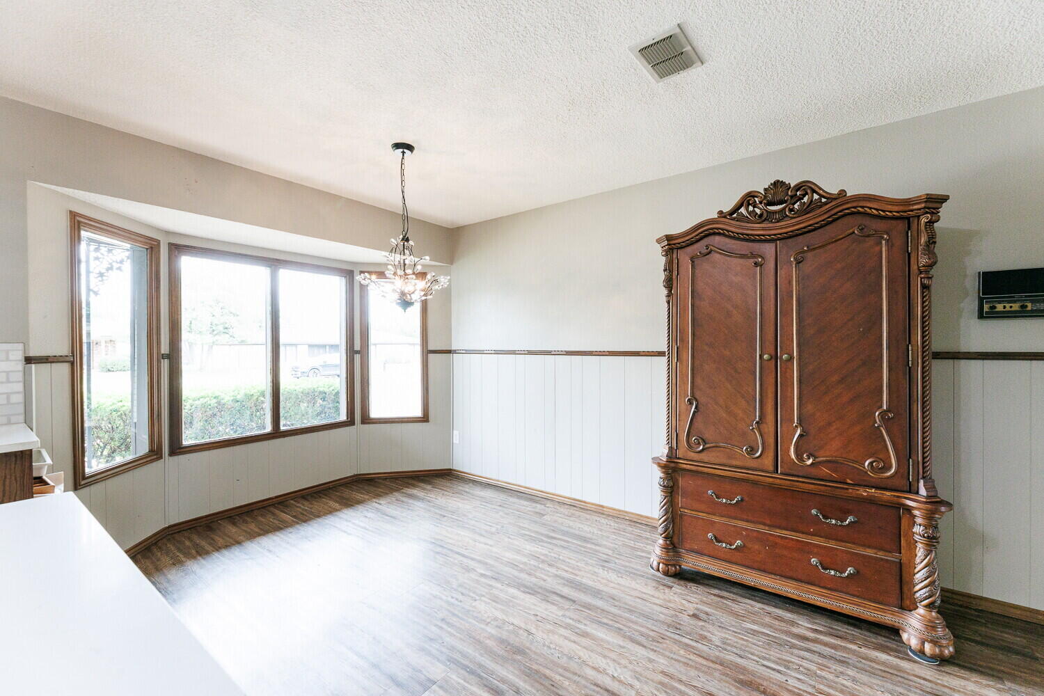 5703 80th Street Lubbock, TX 79424 - Photo 12 of 52 a view of a livingroom with wooden floor and cabinet