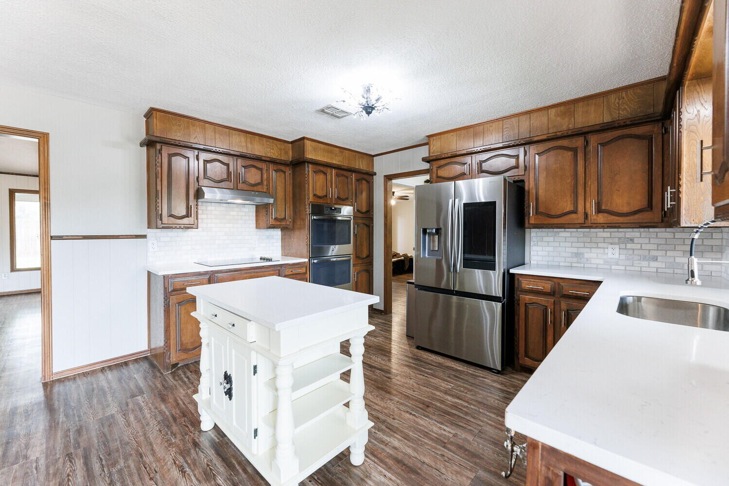 5703 80th Street Lubbock, TX 79424 - Photo 14 of 52 a kitchen with stainless steel appliances granite countertop a sink stove and refrigerator