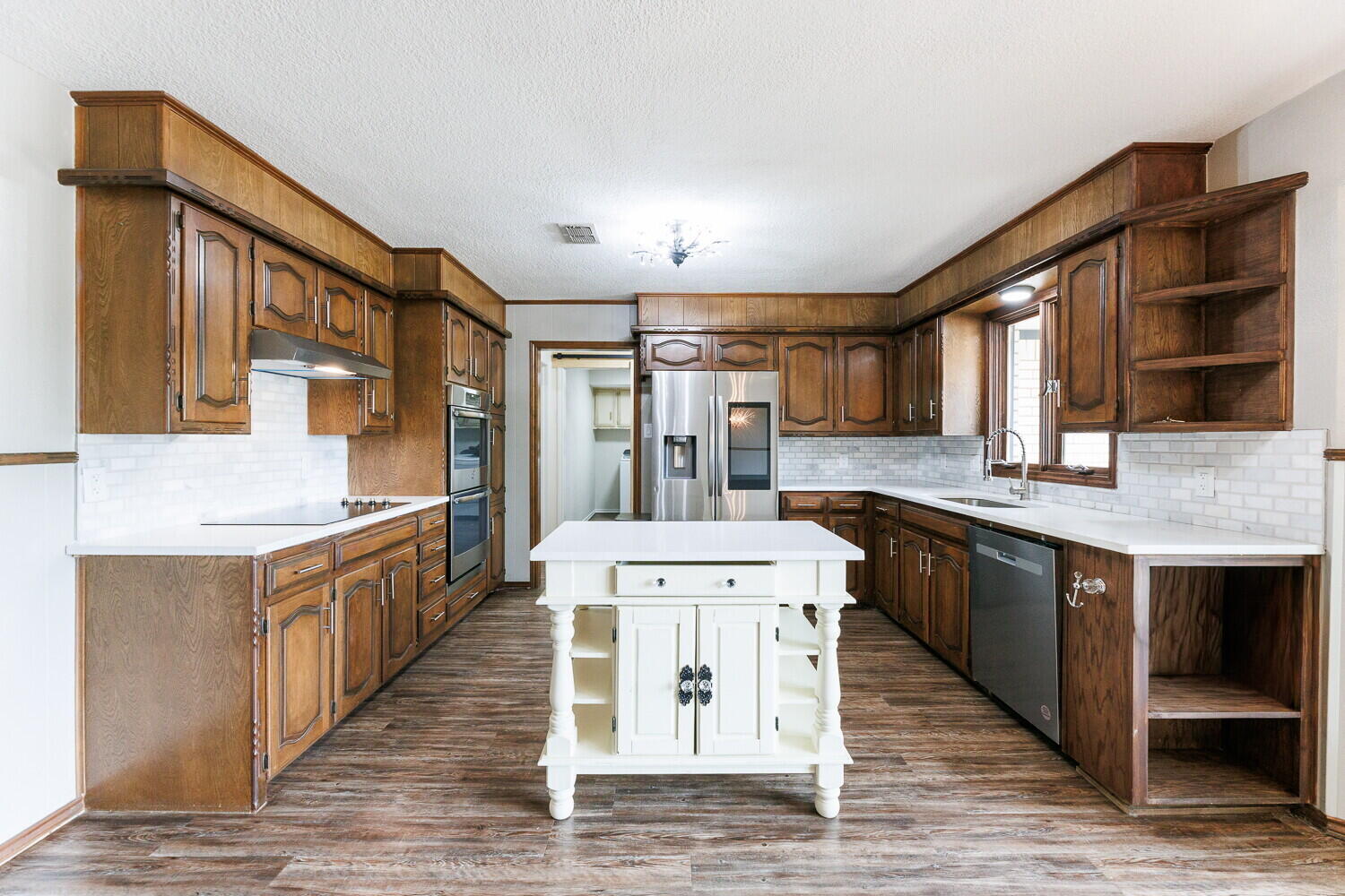 5703 80th Street Lubbock, TX 79424 - Photo 16 of 52 a large kitchen with stainless steel appliances granite countertop a sink stove and cabinets