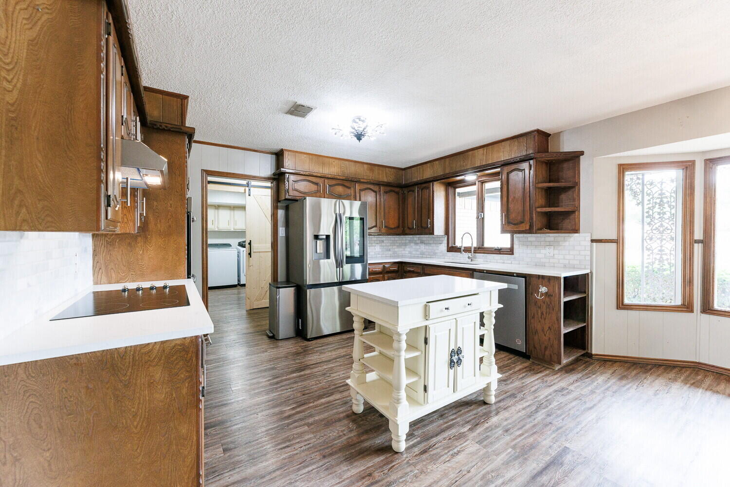5703 80th Street Lubbock, TX 79424 - Photo 17 of 52 a large kitchen with a stove a refrigerator and a dishwasher