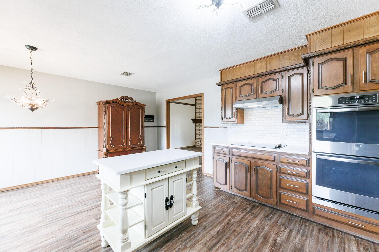 5703 80th Street Lubbock, TX 79424 - Photo 19 of 52 a kitchen with stainless steel appliances granite countertop a stove and a refrigerator