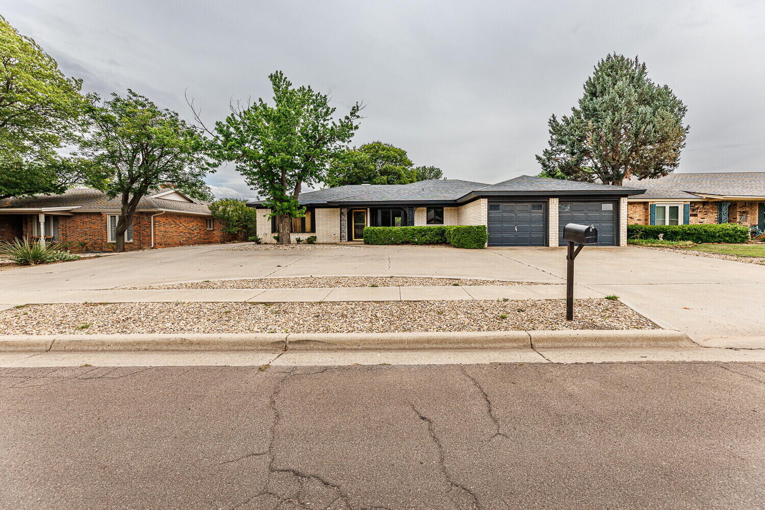 5703 80th Street Lubbock, TX 79424 - Photo 2 of 52 a front view of a house with a pathway