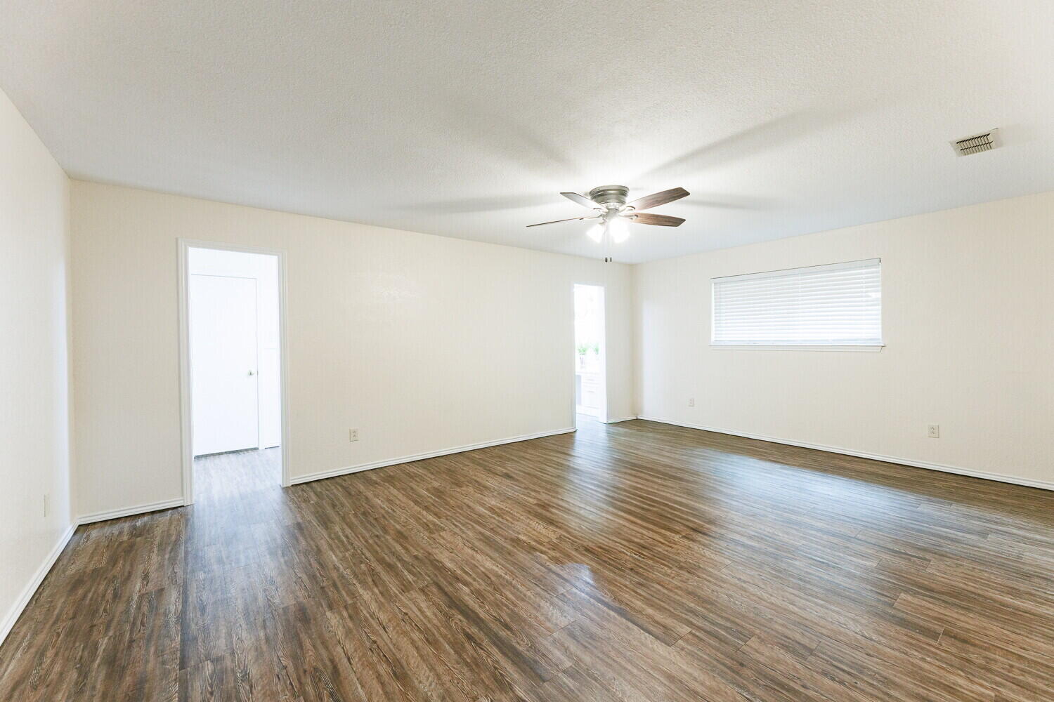 5703 80th Street Lubbock, TX 79424 - Photo 23 of 52 an empty room with wooden floor and window