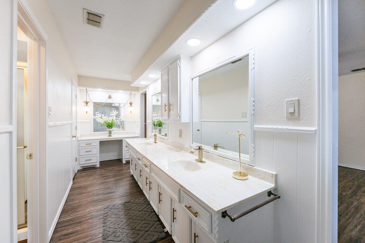 5703 80th Street Lubbock, TX 79424 - Photo 31 of 52 a bathroom with a sink a mirror and a bathtub
